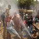 People cool off around punctured water supply lines in Karachi.